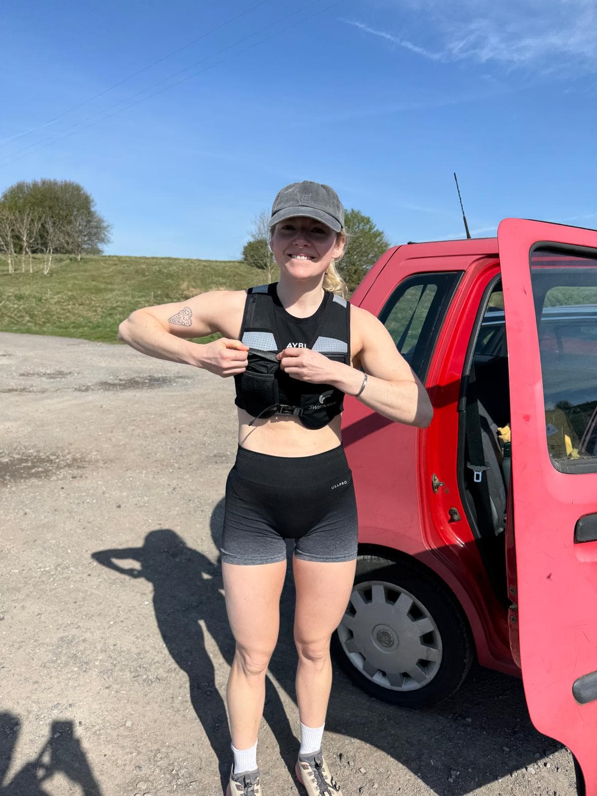 Kitty Douglas, personal trainer, adjusting a weighted vest before a training session